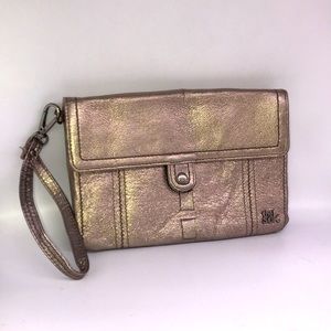 The Sak gold leather wristlet clutch with multi compartments